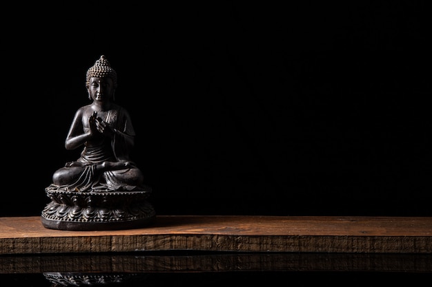 Estátua de Buda sentado em meditação com espaço preto cópia