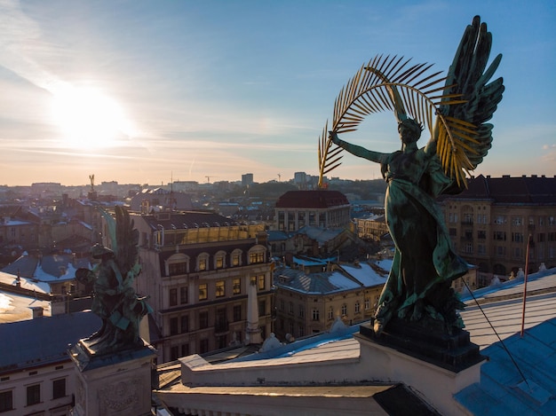 Estátua no telhado de um antigo edifício europeu no pôr do sol