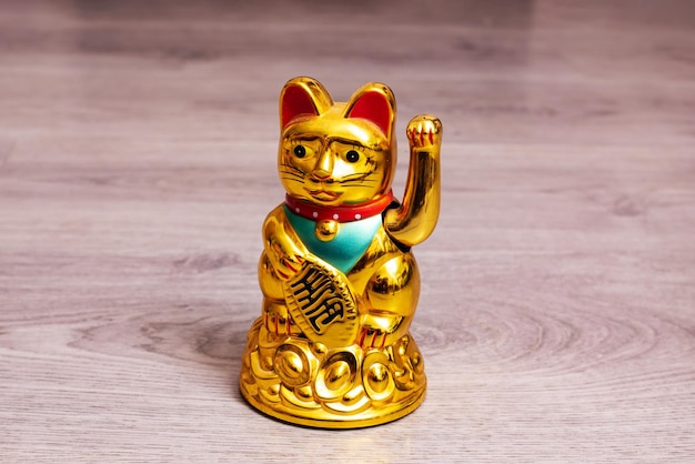 Estatueta de maneki neko no piso de madeira