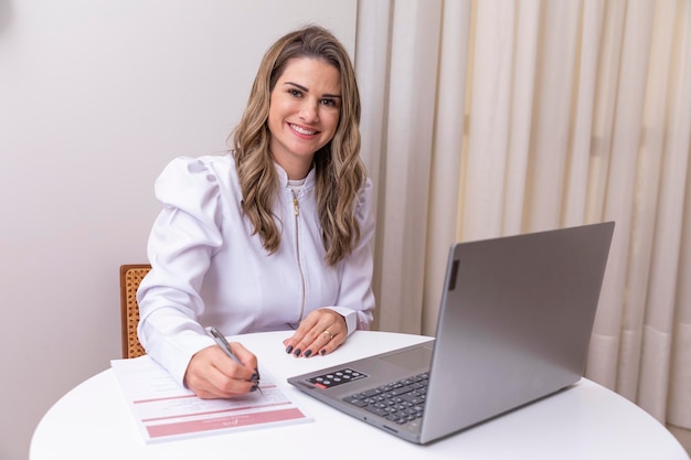 Esteticista doctora exitosa empresaria mujer sonriente estética profesional empresaria En una mesa con un cuaderno