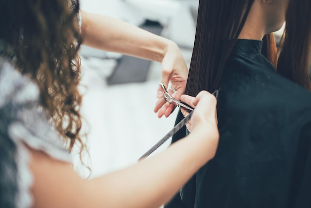 Estilista que trabaja en el corte de pelo y peinado del salón de belleza