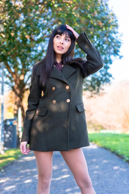 Estilo de vida da primavera. posando de uma jovem caminhando em um parque com uma jaqueta verde