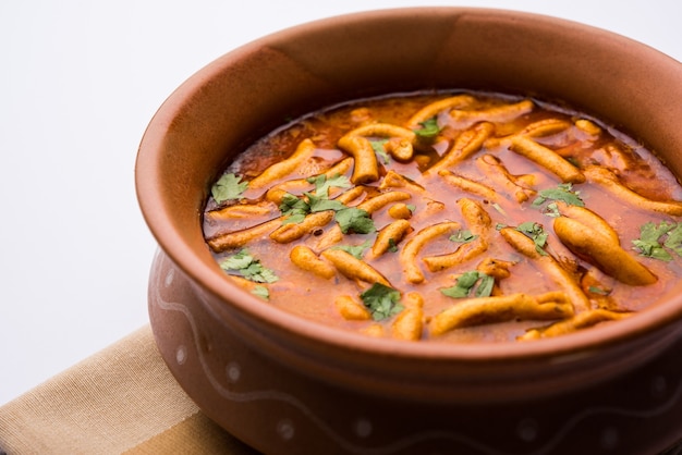 Estilo dhaba sev bhaji, sabzi, curry feito em curry de tomate com gathiya ou ganthia shev, servido em uma tigela ou karahi, foco seletivo