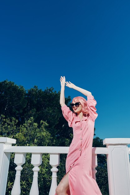 Estilo moderno de vestido rosa de mulher na moda fica perto do conceito de relaxamento do trilho