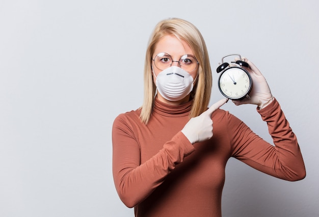 Estilo mujer rubia con reloj despertador