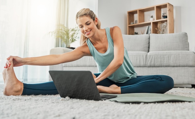Estiramiento de yoga y mujer en la computadora portátil en el hogar transmisión de video de capacitación web clase de yoga o tutorial Zen salud y mujer joven en la computadora de tecnología pilates mat y ejercicio físico y entrenamiento de bienestar