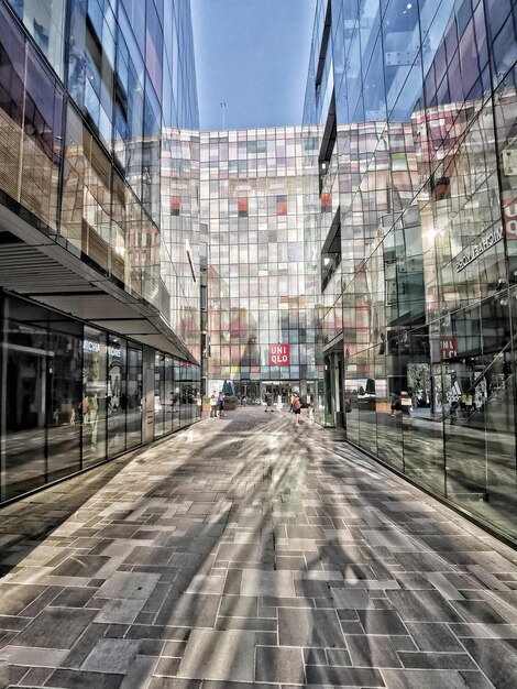 Foto estrada por edifícios na cidade contra o céu