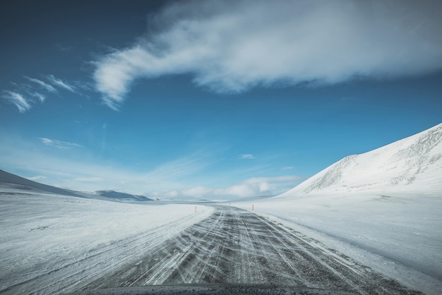 Estrada que leva a uma montanha coberta de neve contra o céu