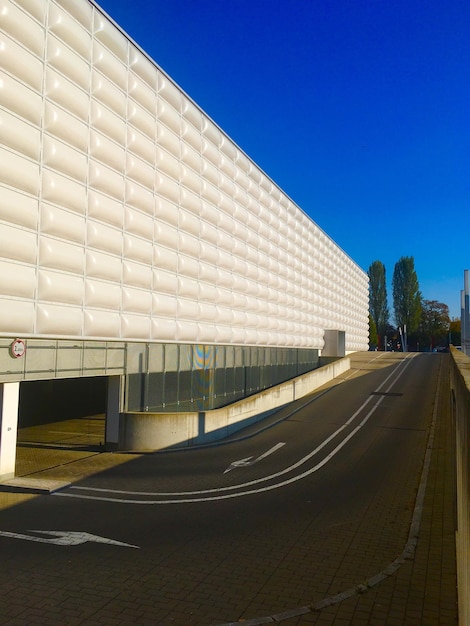 Estrada vazia por edifícios contra um céu azul claro