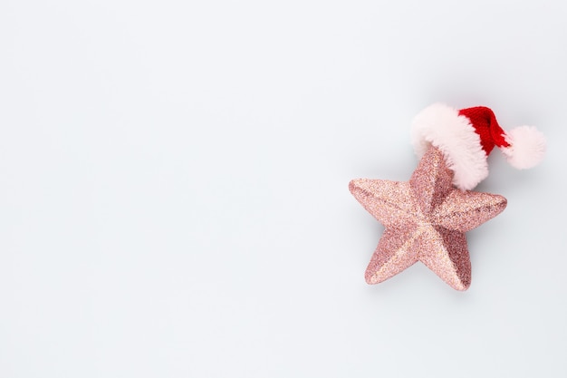 Estrella navideña rosa con decoración de gorro de santa