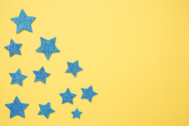 Estrellas de brillo azul con espacio de copia en un amarillo brillante, con cinco estrellas