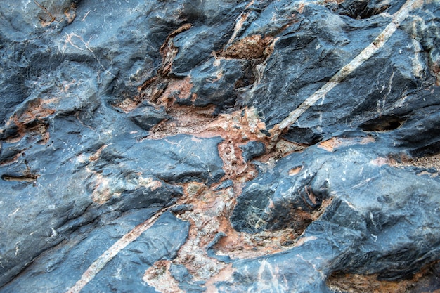 Foto estructura de roca naranja gris azul, textura de fondo