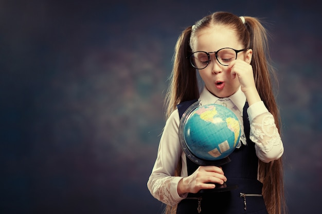 Estudante caucasiana usar óculos vire o globo do mundo.