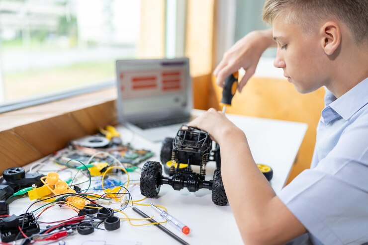 Foto estudante consertando veículo robótico aprende tecnologia em aula de stem edificação