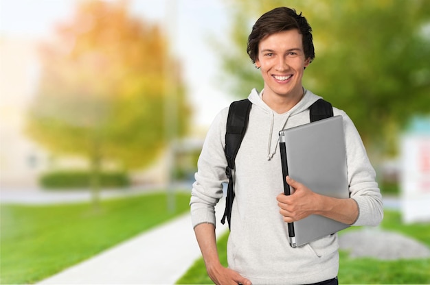 Estudante do sexo masculino com mochila no fundo