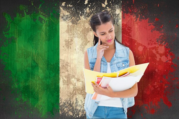 Foto estudiante estudiando desde carpetas contra la bandera de italia en efecto grunge