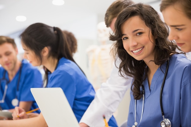 Estudiante de medicina sonriendo a la cámara durante la clase