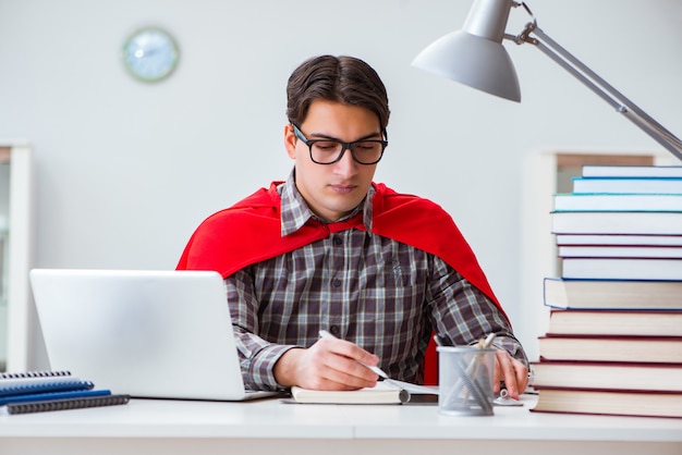 Estudiante superhéroe con libros estudiando para exámenes