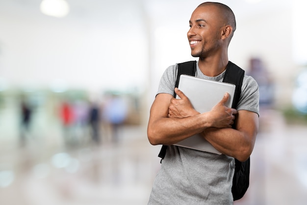 Estudiante varón con mochila en el fondo