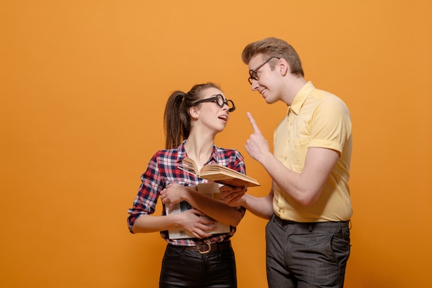 Estudiantes leen un libro sobre fondo amarillo