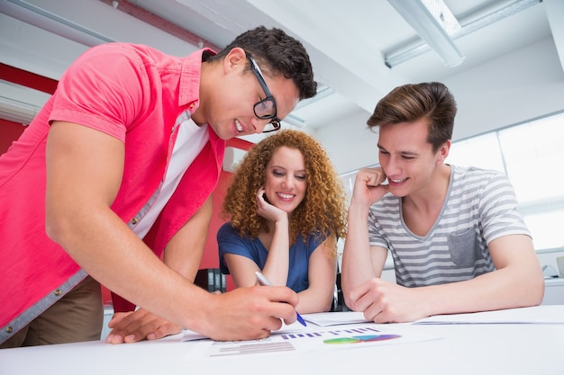 Estudiantes sonrientes trabajando y tomando notas juntos