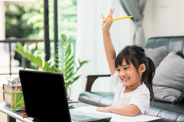 Estudio de clase de aprendizaje en línea de estudiantes asiáticos en línea con laptop en casa.