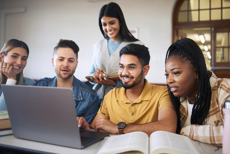 Foto estudo de laptop e alunos com projeto de grupo para curso on-line e aprendizagem e educação com diversidade feliz e trabalho em equipe vídeo de pesquisa estudando e amigos estudantes universitários em uma sala de aula