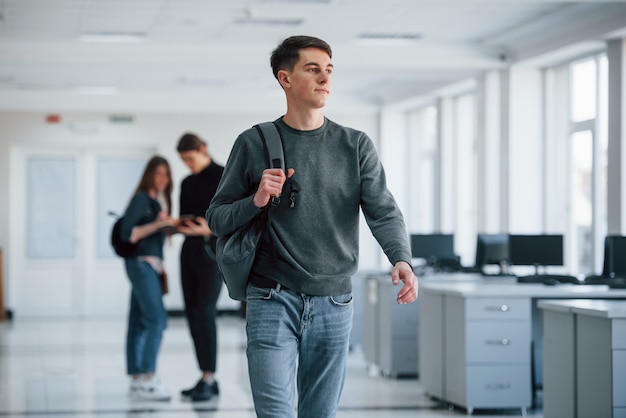 Etnia caucásica. Grupo de jóvenes caminando en la oficina en su tiempo de descanso