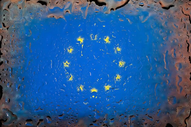 EU-Flagge Flagge der Europäischen Union auf dem Hintergrund von Wassertropfen Flagge mit Regentropfen Spritzer auf Glas