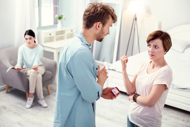 Eu preciso de conselhos. Jovem simpático conversando com a mãe enquanto quer fazer uma proposta