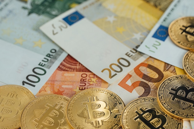 Euro-Banknoten und Bitcoin-Kryptowährungs-Investitionskonzept. Euro-Geld und Kryptowährung goldene Bitcoin-Münze.