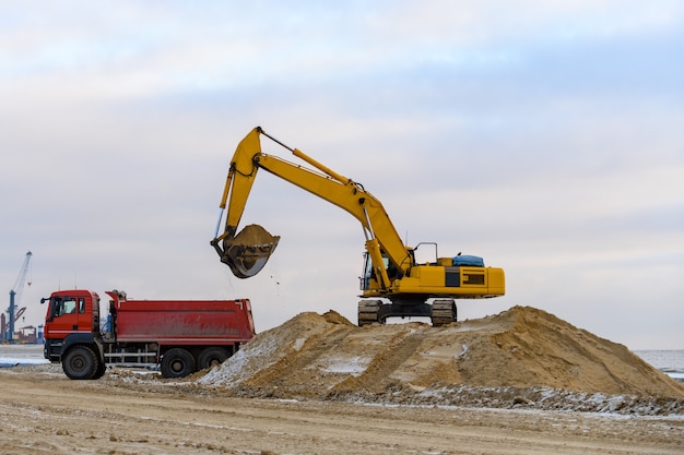 Excavadora amarilla trabajando en obra. La construcción de carreteras.