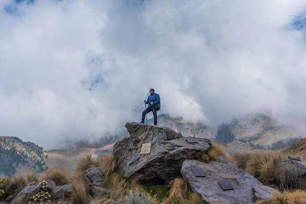 Excursionista de mujer en la cima de una montaña