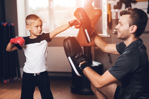 Exercícios de encaixotamento do pai e do filho que treinam na ginástica.