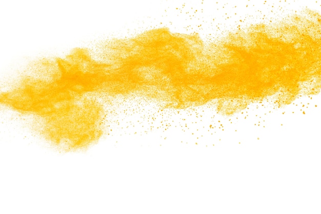 Explosão amarela do pó da cor no fundo branco.