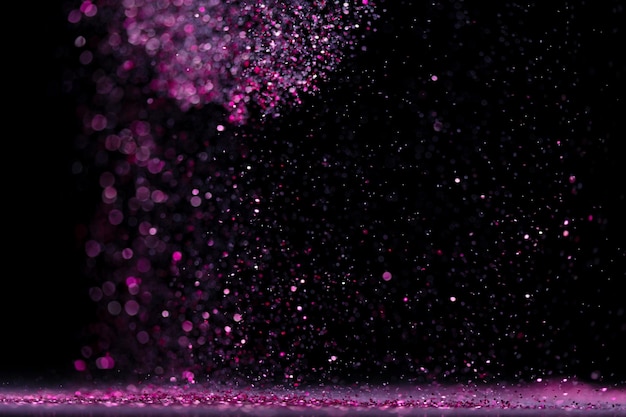 Explosion metallic pink glitter sparkle Choky Glitter powder spark blink celebrate blur foil explode in air fly throw pink glitters particle Black background isolated selective focus Blur bokeh