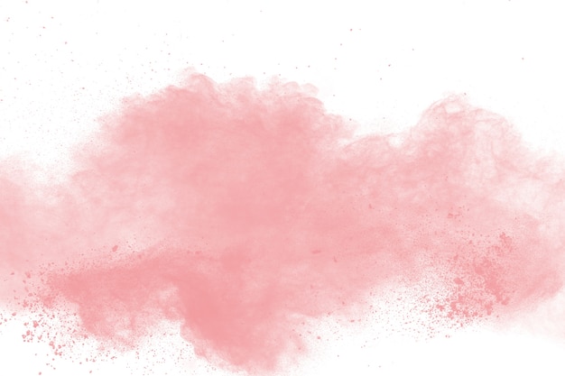 Foto explosión rosada abstracta del polvo en el fondo blanco. congelación de polvo rosa salpicado.