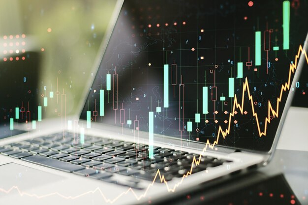 Exposición múltiple de gráficos financieros abstractos en el fondo de la computadora portátil concepto financiero y comercial