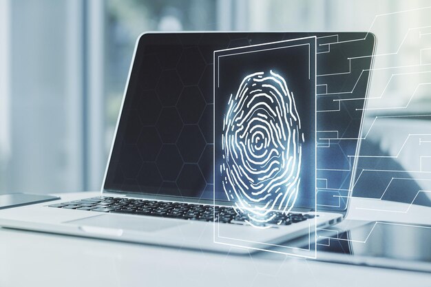 Exposición múltiple del holograma creativo de huellas dactilares en el concepto de datos biométricos personales de fondo de la computadora portátil