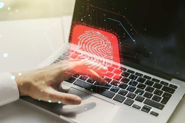 Exposición múltiple del holograma creativo de huellas dactilares con las manos escribiendo en el teclado de la computadora en el concepto de datos biométricos personales de fondo