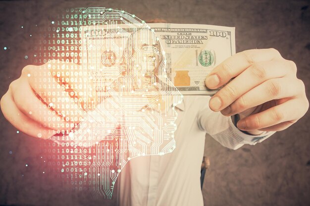 Exposición múltiple del holograma de dibujo cerebral y billetes de dólares estadounidenses y manos de hombre concepto de inversión Ai