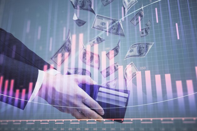 Exposición múltiple del holograma de dibujo de gráficos financieros y billetes de dólares estadounidenses y concepto de análisis de manos de hombre