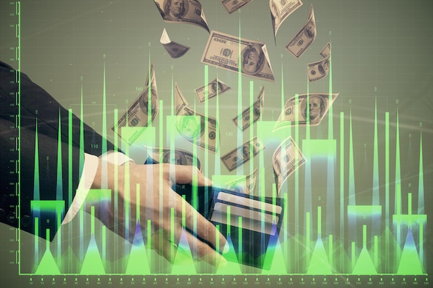 Exposición múltiple del holograma de dibujo de gráficos financieros y billetes de dólares estadounidenses y concepto de análisis de manos de hombre
