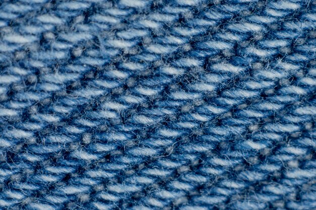 Foto extremo primer plano de las fibras de tela denim azul de textura de fondo macro