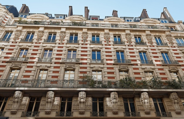 La fachada de la casa tradicional francesa con típicos balcones y ventanas París