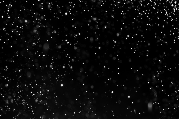 Foto fallender schnee auf dem schwarzen hintergrund.