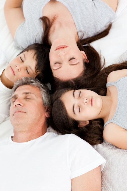 Familia acostada en su cama