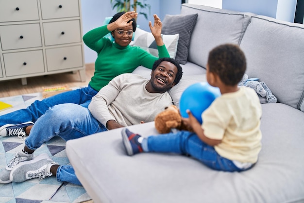 Familia afroamericana jugando con pelota en casa