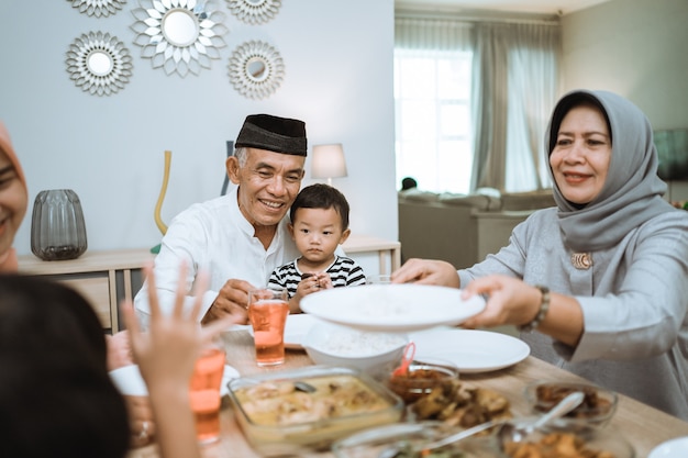 Familia asiática musulmana y abuelos que rompen el ayuno en Ramadán. descanso para cenar iftar