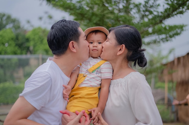 Família asiática pai mãe filho abraça feliz juntos por um feriado